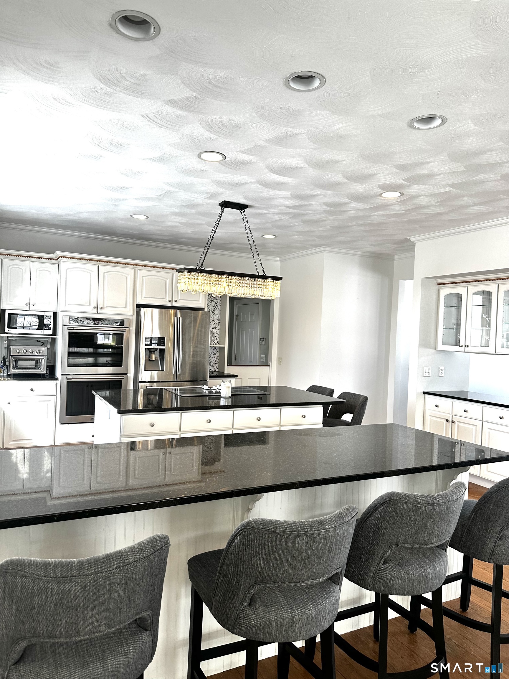 9 Leeward Lane Groton, CT 06340 - Photo 4 of 18 a kitchen with stainless steel appliances granite countertop a stove a sink and a refrigerator