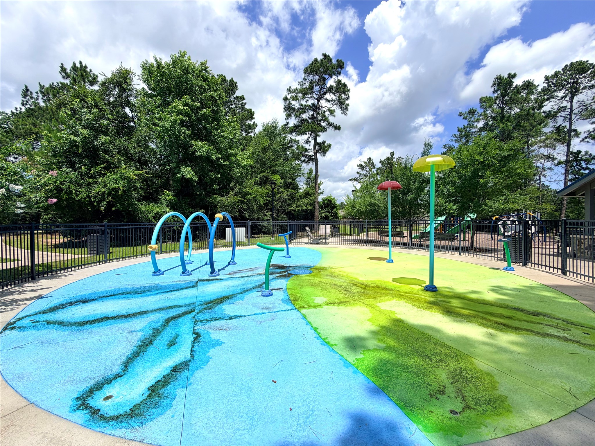 532 Flower Reed Court Magnolia, TX 77354 - Photo 38 of 43 The colorful splash pad in a fenced outdoor area is sure to be a hit with your iittle ones! Virtually enhanced.
