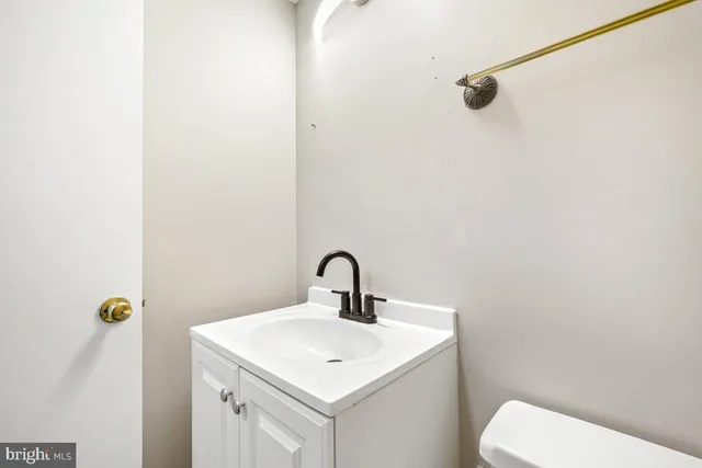 a bathroom with a sink a mirror and toilet