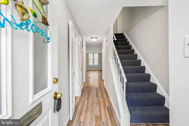 a view of a hallway with wooden floor and entryway