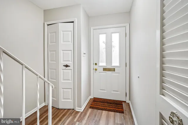 a view of a hallway with wooden floor and entryway
