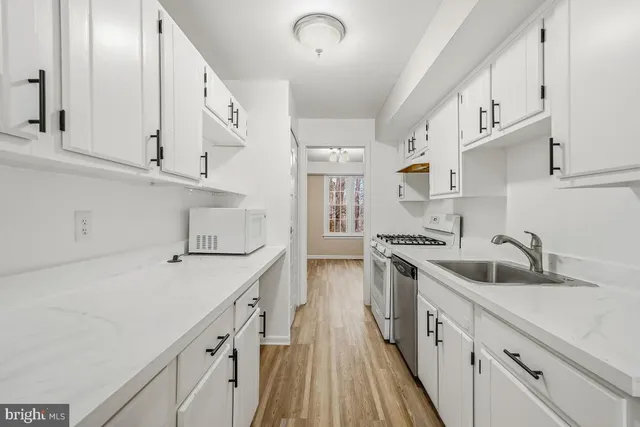 a kitchen with cabinets a sink and appliances