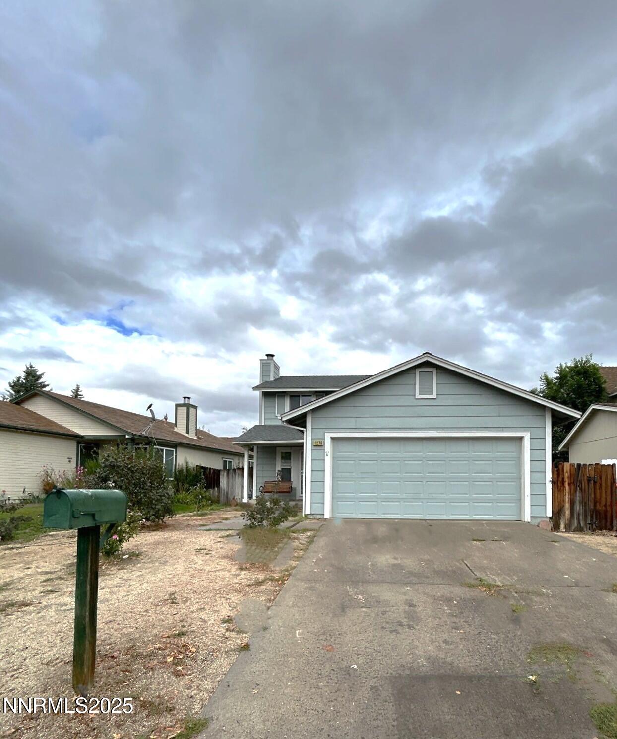 1276 Express Street Sparks, NV 89434 - Photo 1 of 1 a front view of a house with a yard and garage