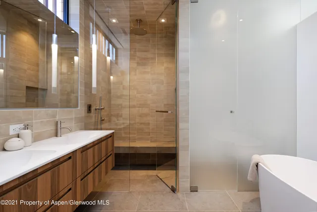a bathroom with a double vanity sink toilet and shower