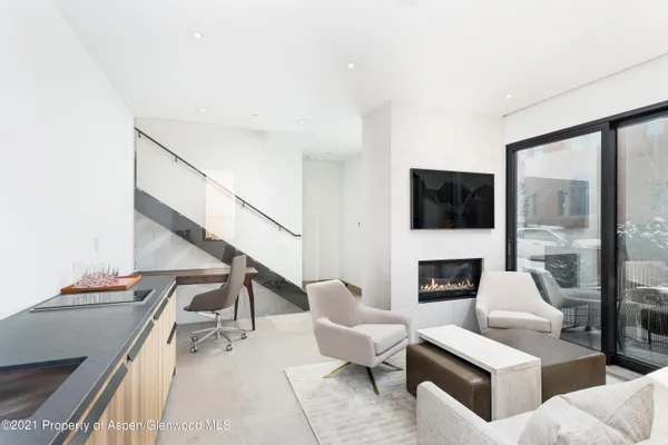 a living room with furniture fireplace and a flat screen tv