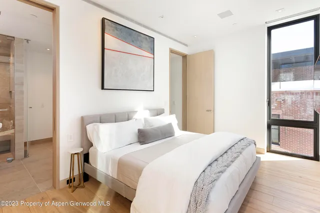 a bedroom with a bed and a large mirror