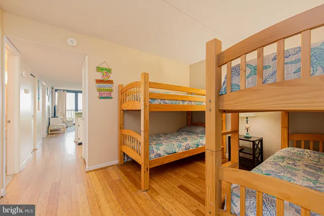 a bedroom with furniture and a wooden floor