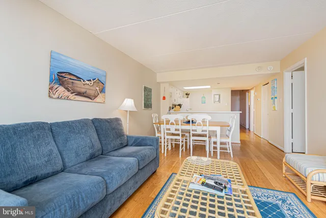 a living room with furniture a rug and a table