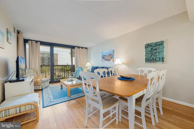 a living room with furniture and large windows