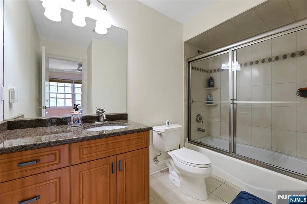22 Meadowlake Drive Mahwah, NJ 07430 - Photo 28 of 39 a bathroom with a granite countertop sink toilet mirror and shower