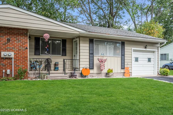 a front view of house with outdoor seating and yard
