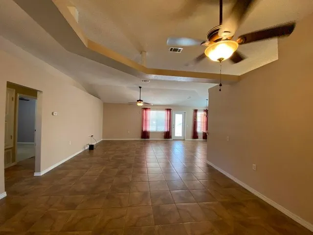 a view of a livingroom with a ceiling fan and window