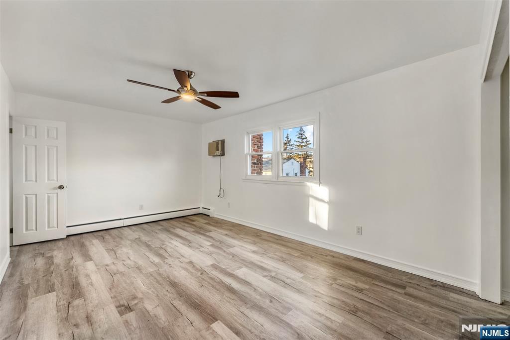 1 Dunn Road West Orange, NJ 07052 - Photo 11 of 20 a view of empty room with wooden floor and fan