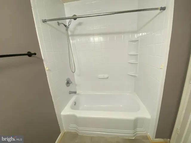 a bathroom with a shower and a bath tub