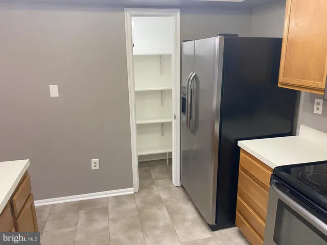 a room with a refrigerator and window