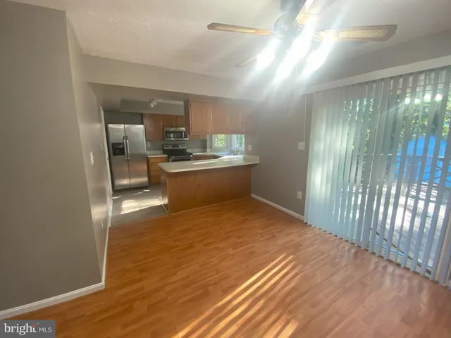 a view of a room with wooden floor and furniture