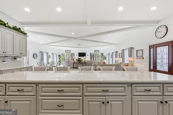 a kitchen with granite countertop stainless steel appliances sink and cabinets