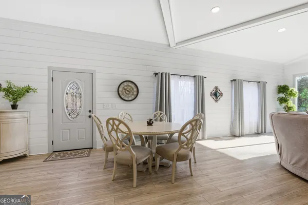 a view of a dining room with furniture and wooden floor