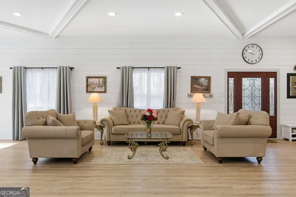 a living room with furniture and a large window