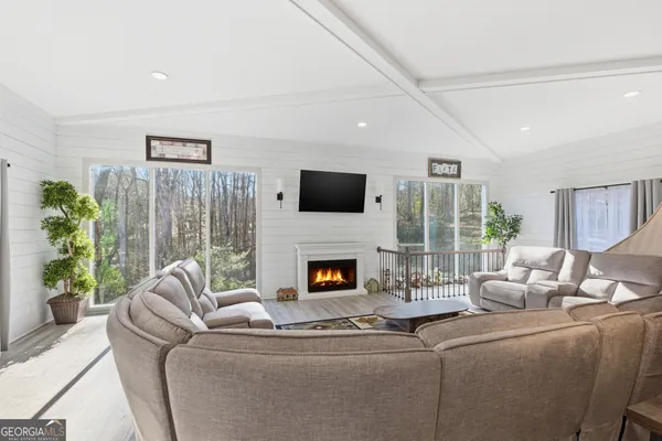 a living room with furniture fireplace and a flat screen tv