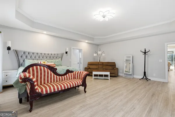 a bedroom with furniture and a wooden floor