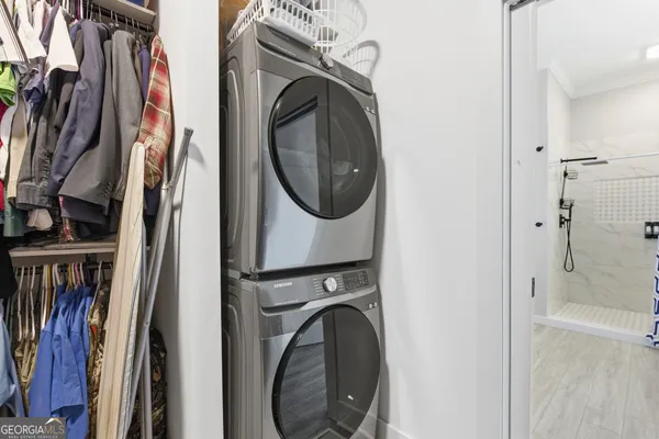 a view of walk in closet with clothes and shoes