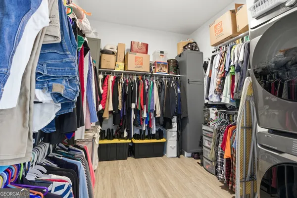 a view of walk in closet with clothes