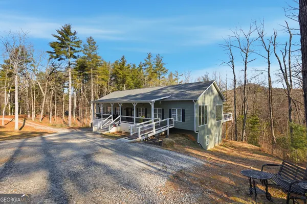 a view of a house with backyard porch and sitting area
