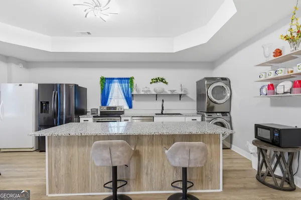 a kitchen with stainless steel appliances granite countertop a stove and a refrigerator