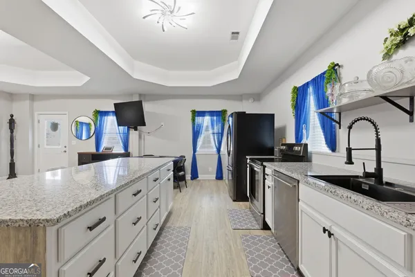 a utility room with sink dryer and washer