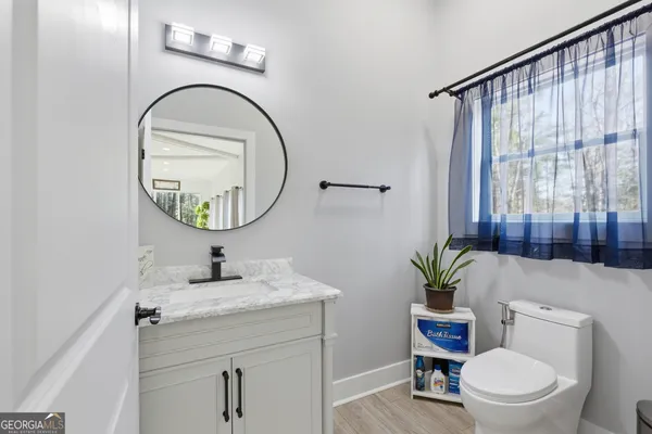 a view of a balcony with two chairs and wooden floor
