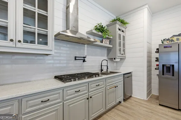 a kitchen with stainless steel appliances a counter space and cabinets