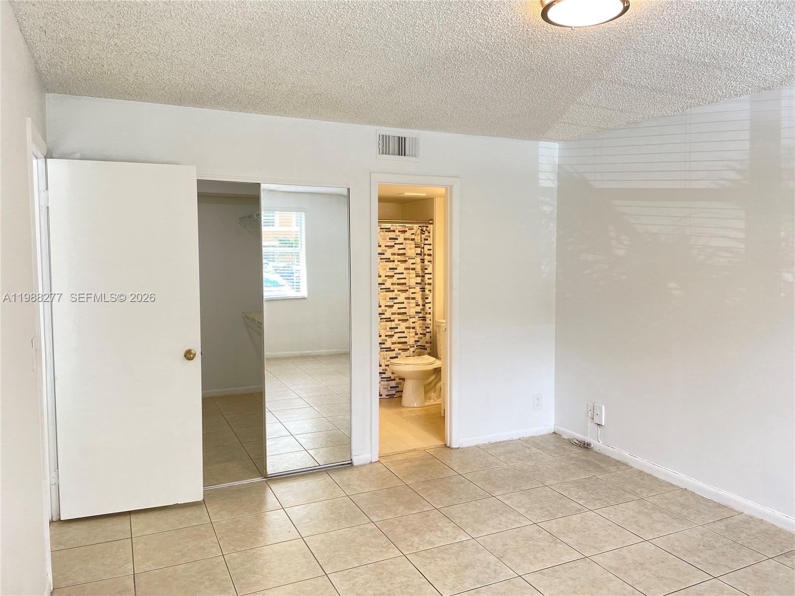 8871 Wiles Road, Unit 105 Coral Springs, FL 33067 - Photo 11 of 43 a view of an empty room and window