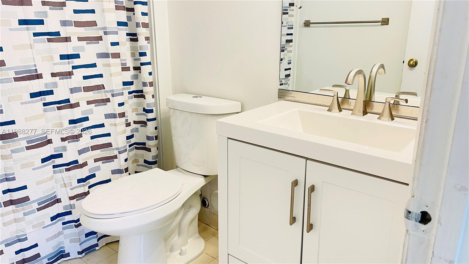 8871 Wiles Road, Unit 105 Coral Springs, FL 33067 - Photo 13 of 43 a bathroom with a sink toilet and shower