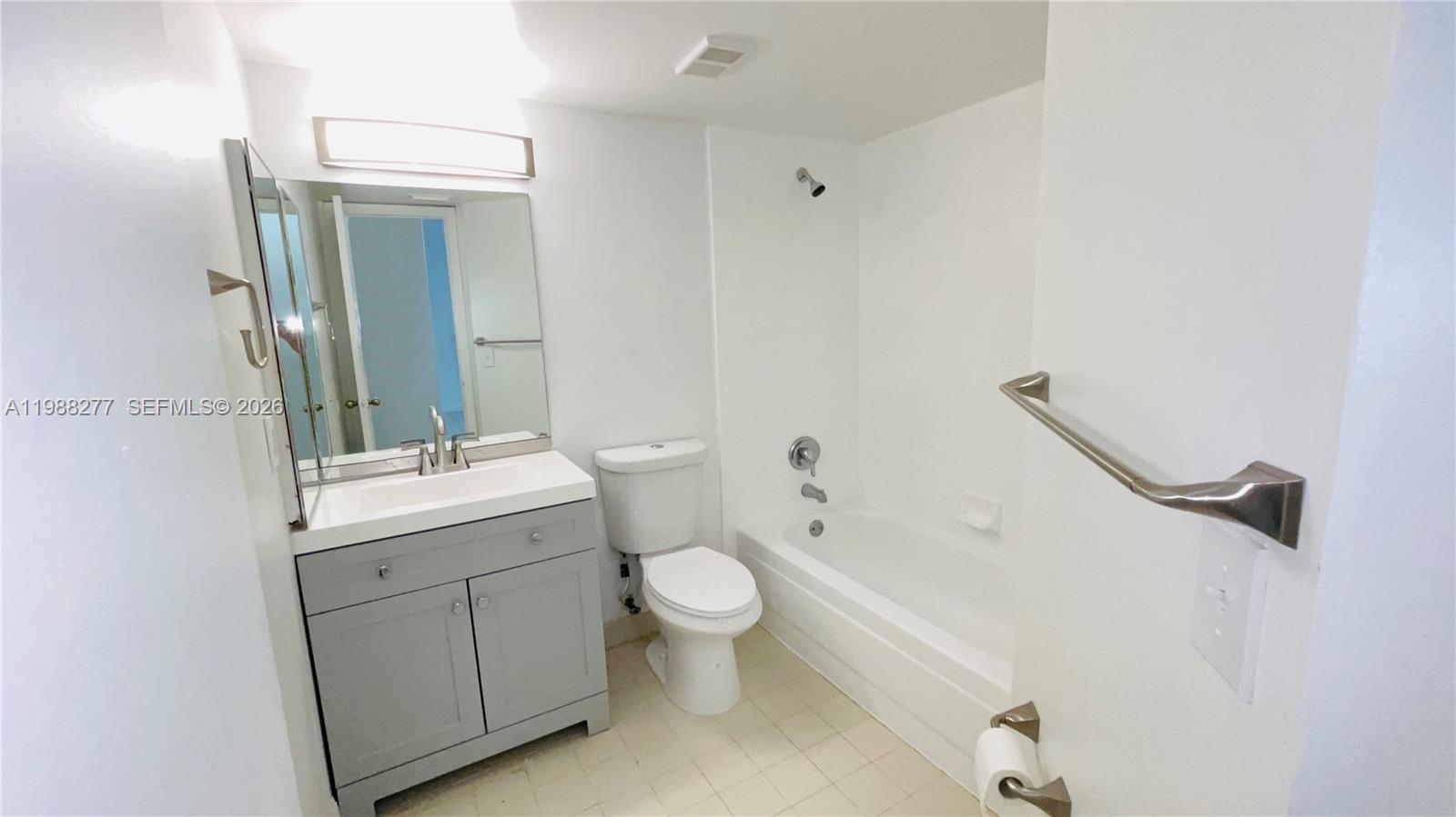 8871 Wiles Road, Unit 105 Coral Springs, FL 33067 - Photo 18 of 43 a bathroom with a granite countertop sink toilet and shower