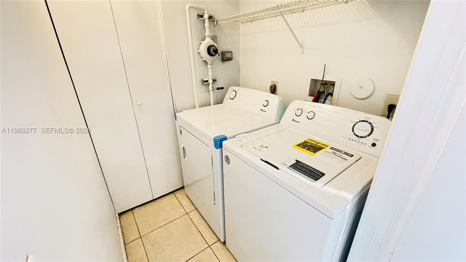 8871 Wiles Road, Unit 105 Coral Springs, FL 33067 - Photo 19 of 43 a utility room with dryer and washer