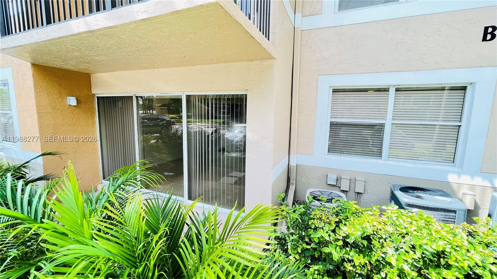 8871 Wiles Road, Unit 105 Coral Springs, FL 33067 - Photo 22 of 43 a house with a plant in front of it