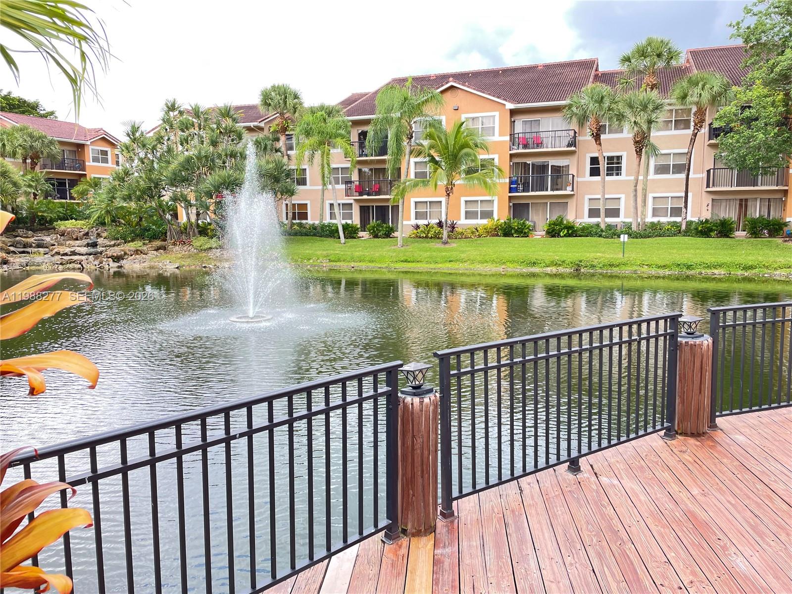8871 Wiles Road, Unit 105 Coral Springs, FL 33067 - Photo 25 of 43 a view of swimming pool with deck and plants