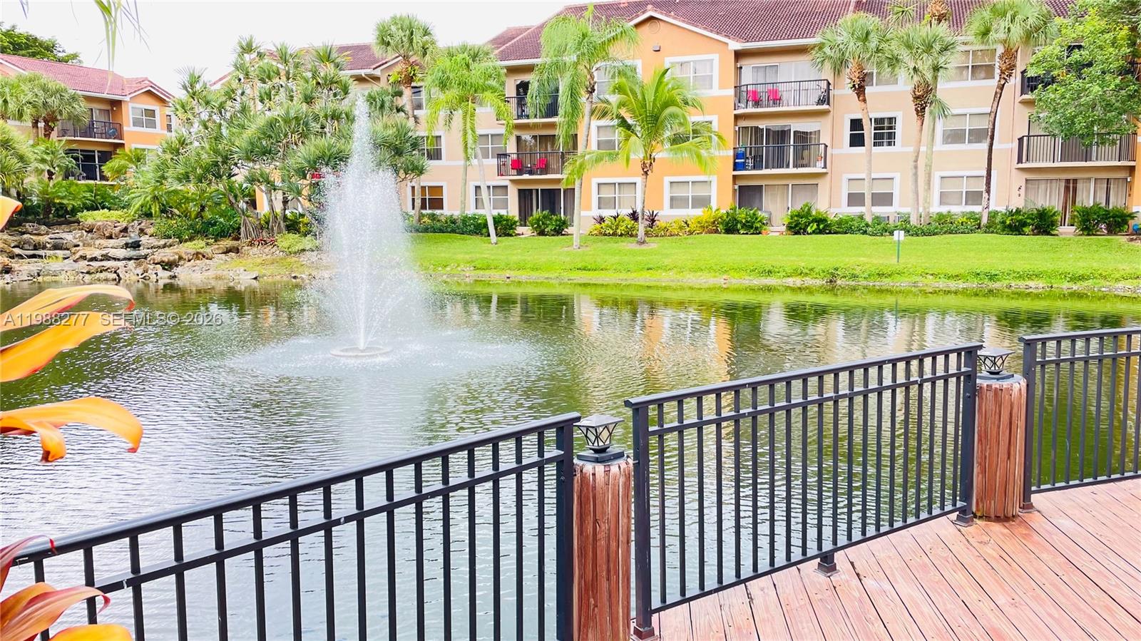 8871 Wiles Road, Unit 105 Coral Springs, FL 33067 - Photo 28 of 43 a view of building with garden and deck