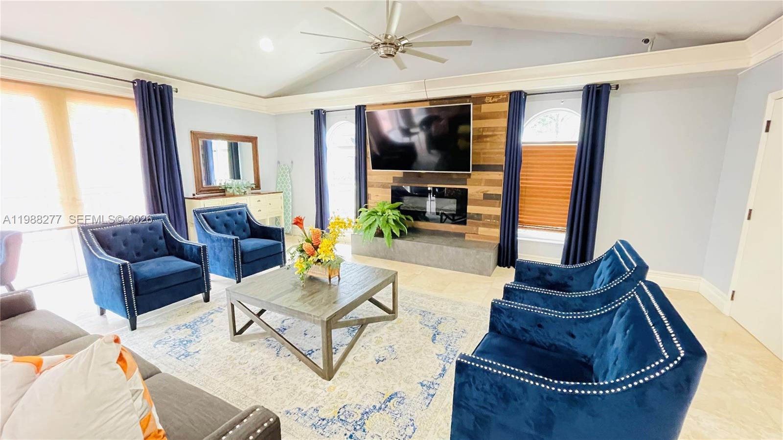 8871 Wiles Road, Unit 105 Coral Springs, FL 33067 - Photo 31 of 43 a living room with furniture and a large window