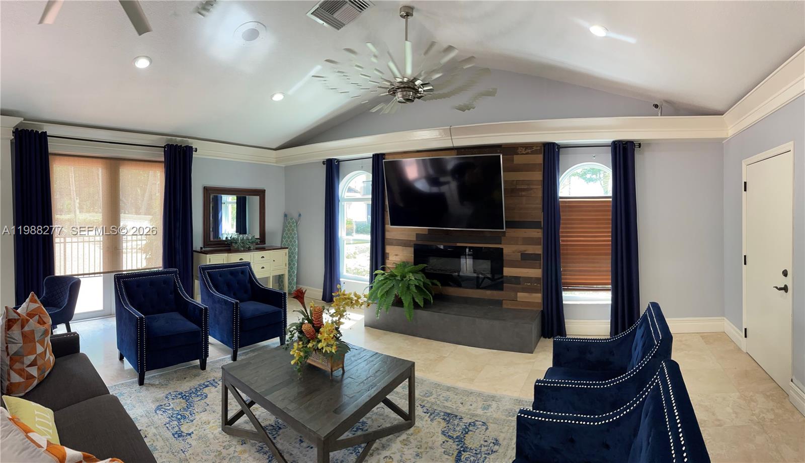 8871 Wiles Road, Unit 105 Coral Springs, FL 33067 - Photo 41 of 43 a living room with furniture fireplace and flat screen tv