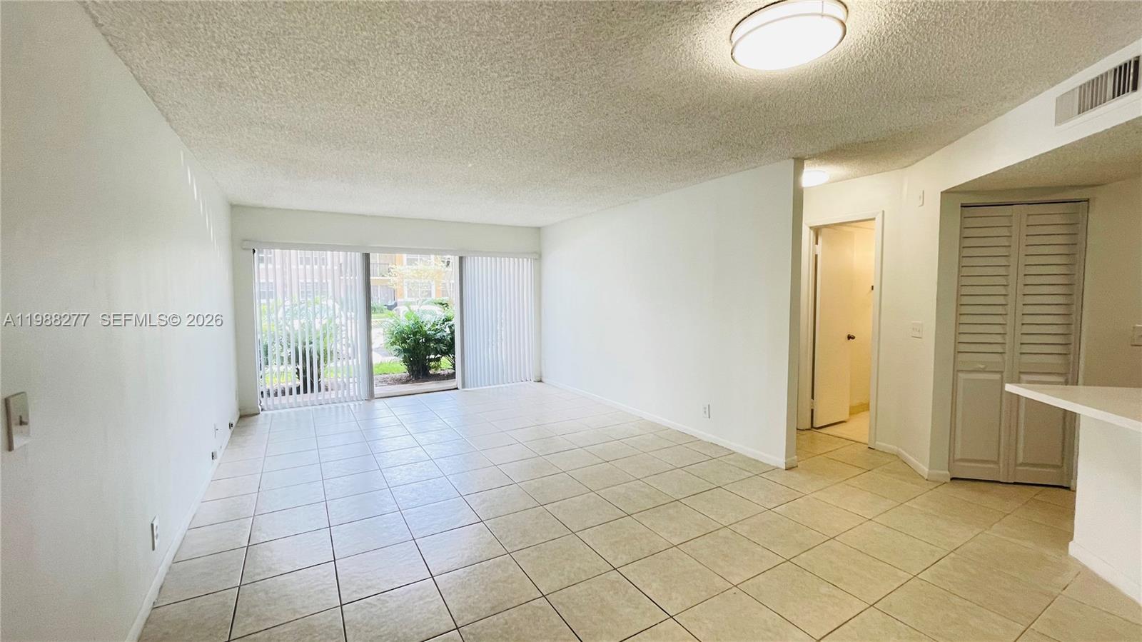 8871 Wiles Road, Unit 105 Coral Springs, FL 33067 - Photo 43 of 43 an empty room with windows