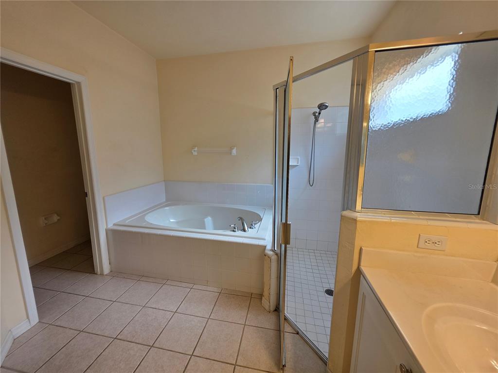 2074 Northwest 101st Street Gainesville, FL 32606 - Photo 10 of 16 a bathroom with a bathtub and a shower