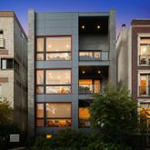 front view of a brick house with a large windows
