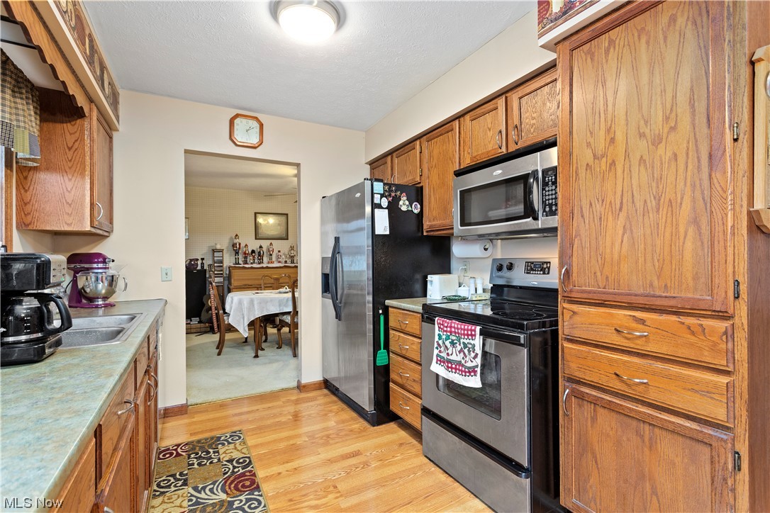 3465 Yost Road Litchfield, OH 44253 - Photo 4 of 27 Kitchen with light wood-type flooring and stainless steel appliances