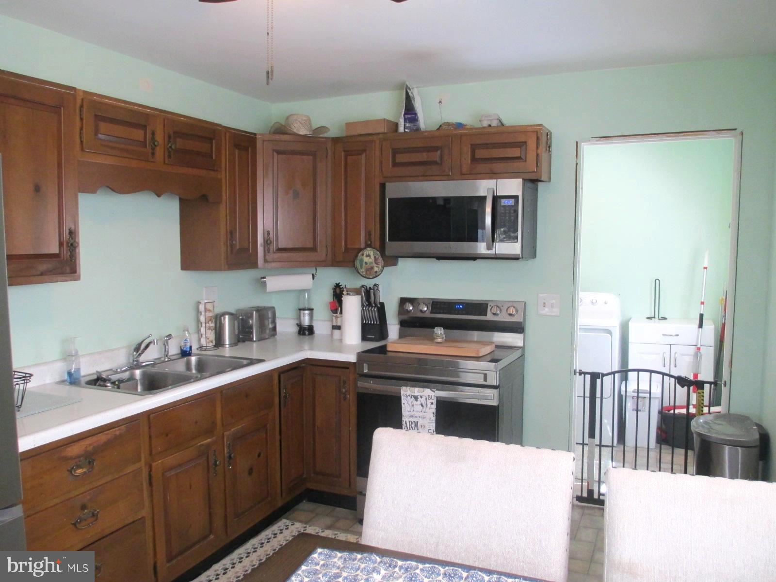 25241 Porters Grove Road Worton, MD 21678 - Photo 11 of 22 a kitchen with stainless steel appliances a stove microwave and sink
