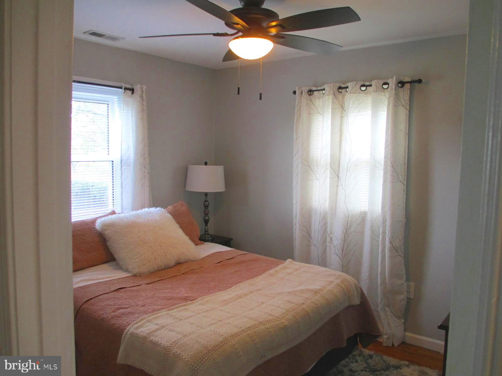 25241 Porters Grove Road Worton, MD 21678 - Photo 16 of 22 a bedroom with a bed and a chandelier