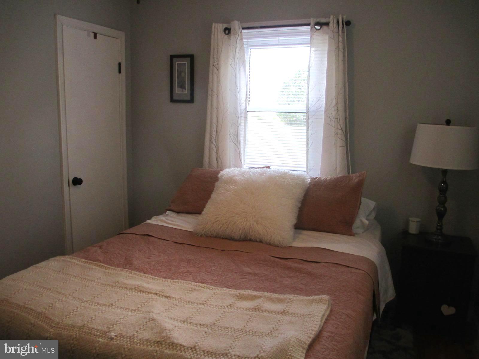 25241 Porters Grove Road Worton, MD 21678 - Photo 17 of 22 a bedroom with a bed and a window