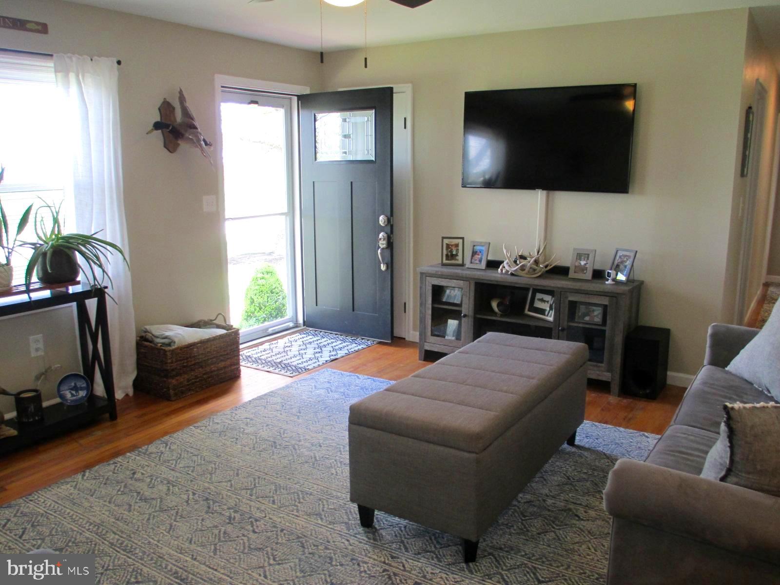 25241 Porters Grove Road Worton, MD 21678 - Photo 7 of 22 a living room with furniture and a flat screen tv