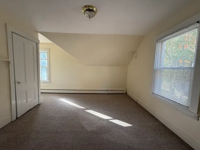 an empty room with a empty space and windows
